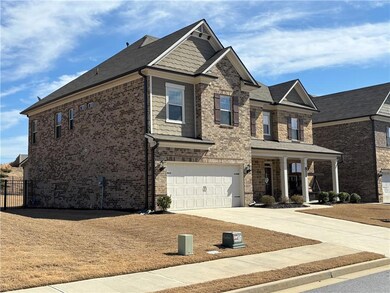 Craftsman-style house with brick siding, an attached garage, driveway, and fence
