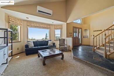 Carpeted living room with a wall mounted air conditioner and high vaulted ceiling