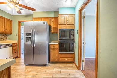 Kitchen featuring ceiling fan, black appliances, a