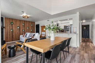 Dining room with visible vents, light wood finish