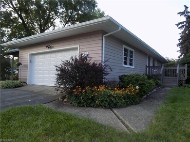 Side view of home with new garage door, vinyl over
