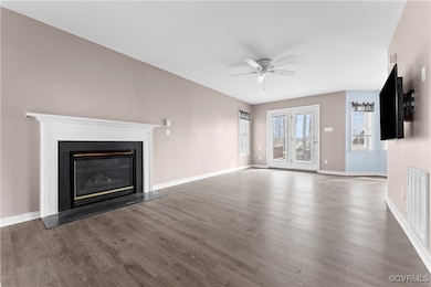 Unfurnished living room with a glass covered firep