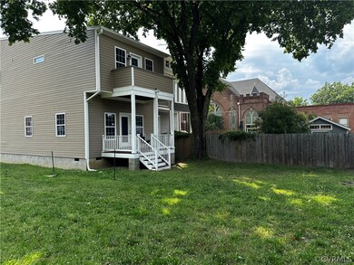 Rear view of house featuring a yard