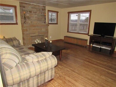 Living room with real hardwood flooring & decorati