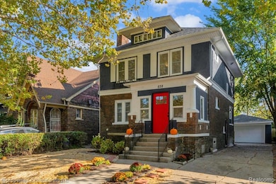 Traditional style home with brick siding, an outbuilding, and a garage