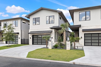 Contemporary house with a standing seam roof, stone siding, stucco siding, and a metal roof