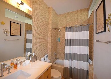Full bathroom featuring toilet, tile walls, showe