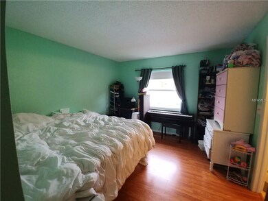 Master bedroom with newer wood laminate flooring.