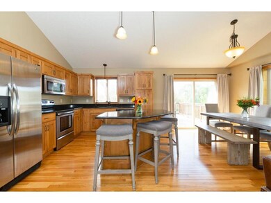 The kitchen features granite counters and stainles