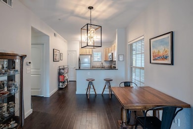 Dining area featuring a chandelier and dark wood-