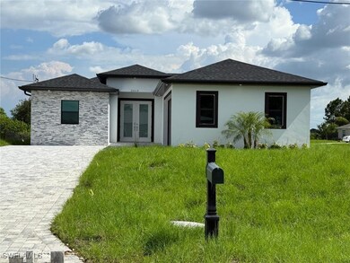 View of front of home featuring french doors, stucco siding, roof with shingles, and stone siding
