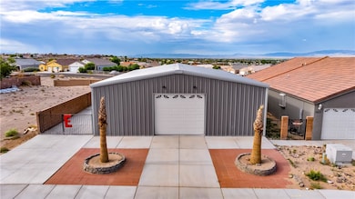 View of front facade with a gate, an outbuilding,