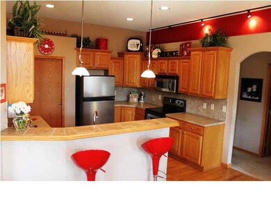 Conversation is easy with kitchen open to hearth a