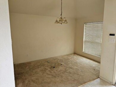 Formal dining with an inviting chandelier and vaul