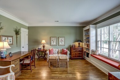 A spacious study, located off the entryway, has bu