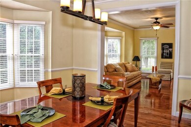 The formal dining room offers hardwood floors, cro