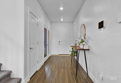 Entrance foyer with dark wood finished floors, stairway, and recessed lighting