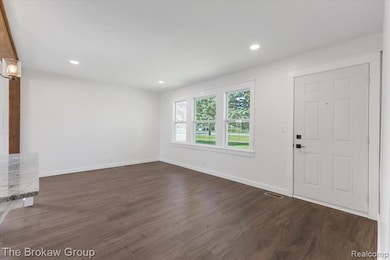 Entryway with dark wood-style floors and recessed lighting