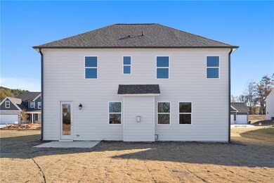 Rear view of property featuring a patio area and a