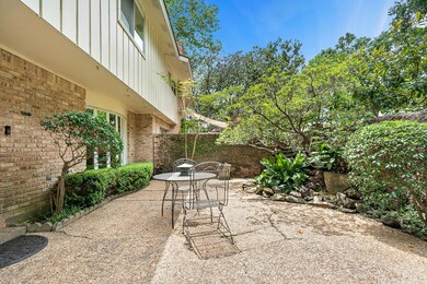 The front patio surrounded by brick walls offers s