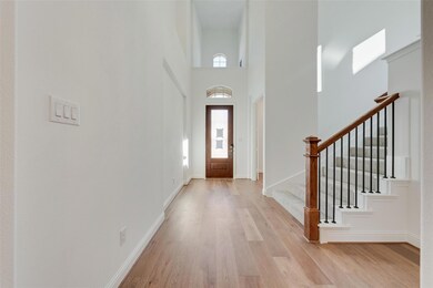 Foyer featuring a wealth of natural light, a high 