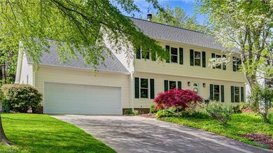 Mature trees and a beautiful Japanese Maple greet you at 905 Northshore Court!
