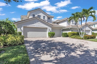 View of front facade featuring a garage, stucco siding, and decorative driveway