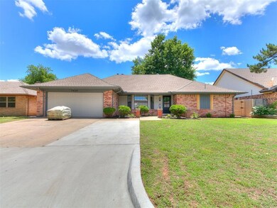 Ranch-style house with concrete driveway, a garage, brick siding, and a shingled roof