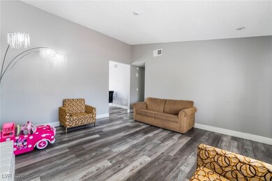 Living area with vaulted ceiling, wood finished fl