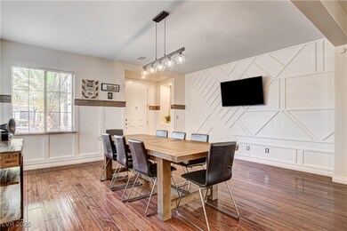 Entry/dining room with a decorative wall and wood-
