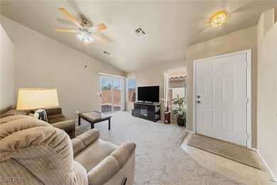 Carpeted living area featuring visible vents, loft