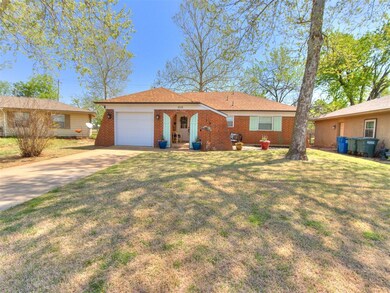 Single story home featuring a garage, driveway, a 