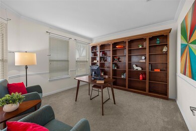 Home office with light colored carpet and ornament