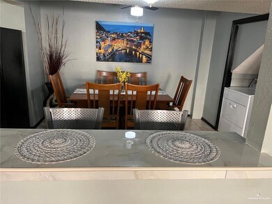Dining space featuring washer / clothes dryer, tile patterned floors, a textured wall, and ceiling fan