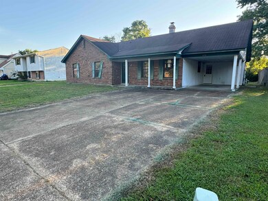 Single story home featuring a carport and a front 