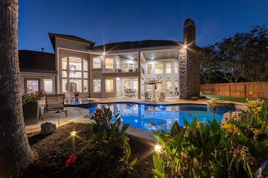 The backyard shines with soft evening lighting, palm trees swaying, and water views that take your breath away.