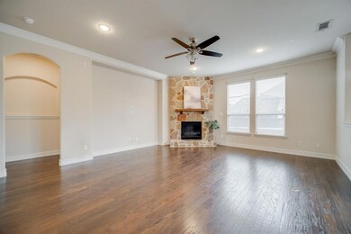 You'll enjoy the stately stone gas fireplace and lovely wood floors in the family room! Entry to the Master Suite is to the left.