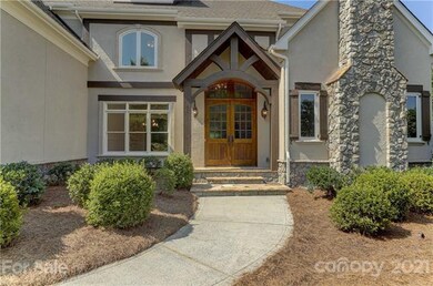 Covered front entry with beams & stone steps