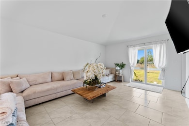 Living area with light tile patterned floors and l