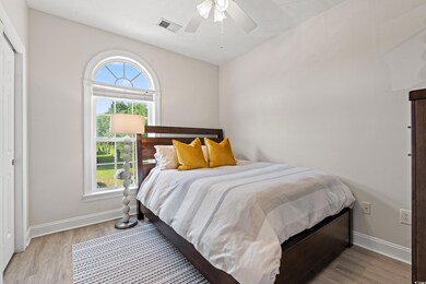 Bedroom featuring ceiling fan, light wood-type flo