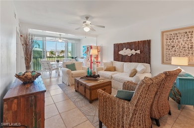 Living room with ceiling fan and light tile patter