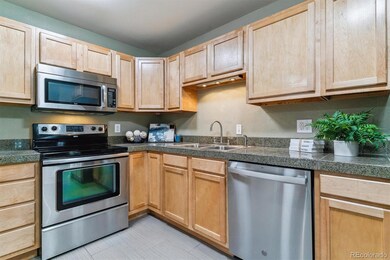Kitchen features stainless steel appliances and cherry oak cabinets