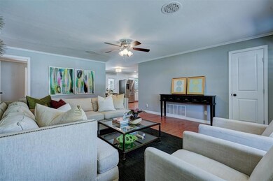 Living room featuring ceiling fan, hardwood / wood
