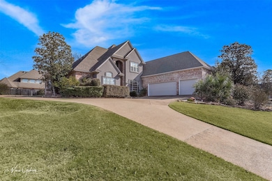 View of front of home featuring a garage and a front yard