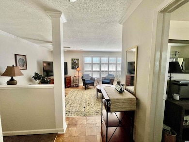 Living room with a textured ceiling, ceiling fan, 