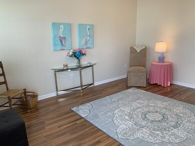 Sitting room featuring baseboards and wood finished floors