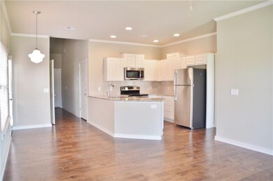 Lower level - open floor plan with hardwood floors, granite, crown molding, recessed light, dining light for EIK area, Master bedroom, stackable laundry and powder bath *pictures are not of actual home but similar colors may vary