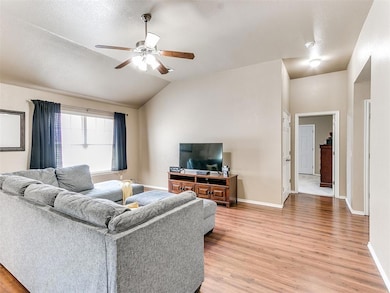 Living room with a textured ceiling, lofted ceilin