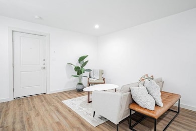 Living area with light hardwood / wood-style floor