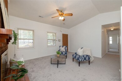 Family room with ceiling fan, a fireplace, vaulted